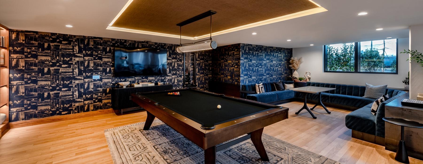 a room with a pool table and couches