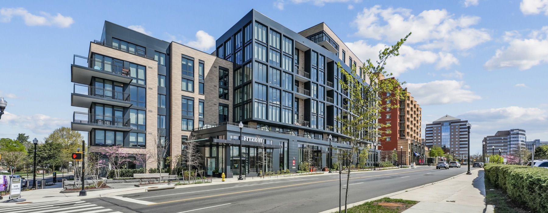 Building exterior with trees and street